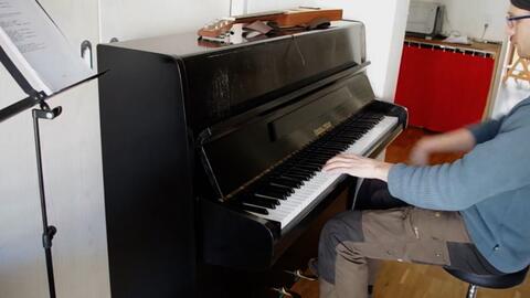 A musician playing a grand piano, capturing the harmony of art and sound.