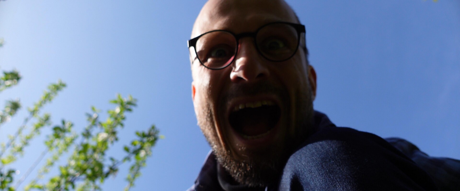 An expressive portrait capturing the passion of performance against a bright sky.