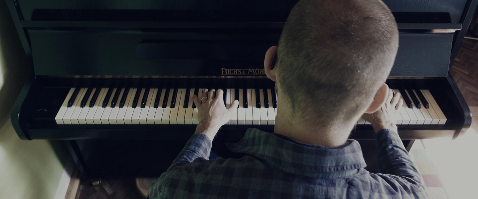 Hands poised over the keys of a piano, ready for musical expression.