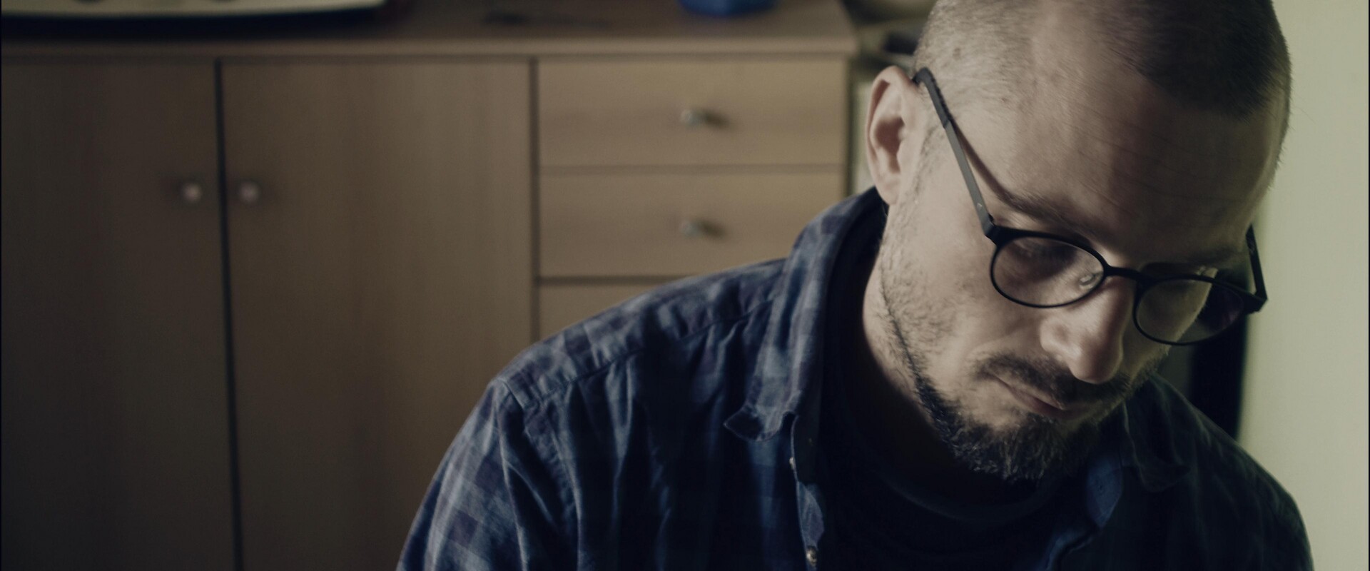 Contemplative portrait of the artist in his creative space.