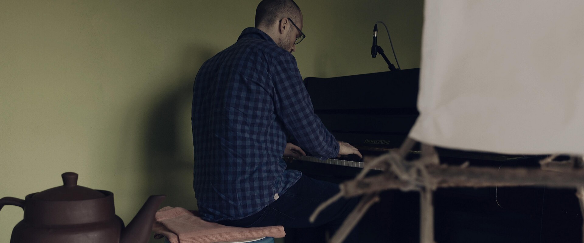 A musician immersed in the art of the piano.